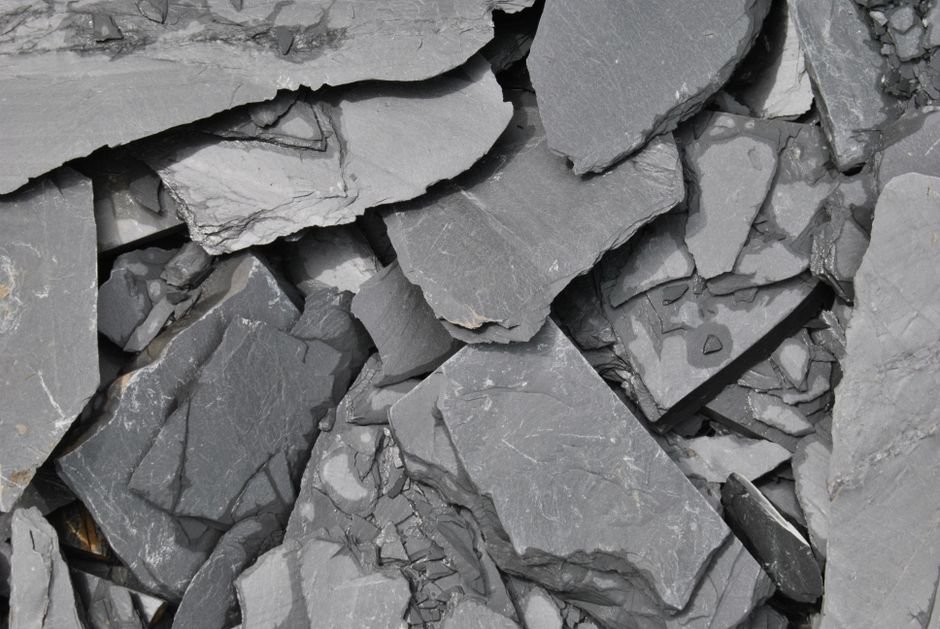 Mineral Cleavage and Fracture — Why Crystals Split Along Clean Planes Broken slate rock split into flat sheets along its natural planes, the same cleavage behavior seen in fluorite and selenite
