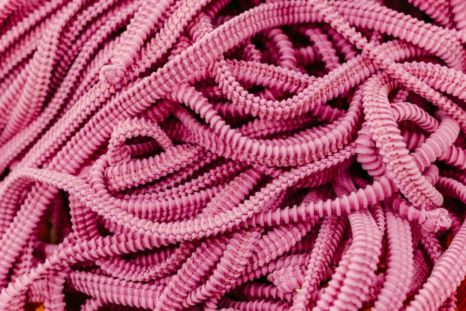 Close-up of stretch elastic cords showing the polymer fibers that fatigue and snap in beaded bracelets