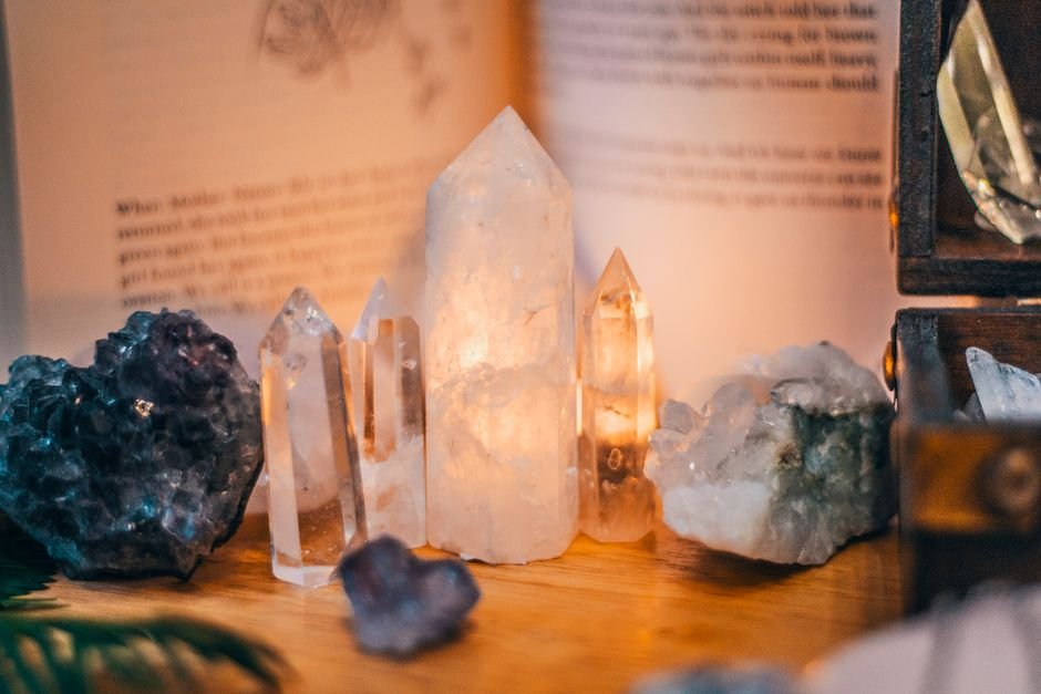 Can I Keep Both the Old and New Crystal — Yes, They Coexist Collection of quartz towers and amethyst clusters displayed together, older and newer stones side by side
