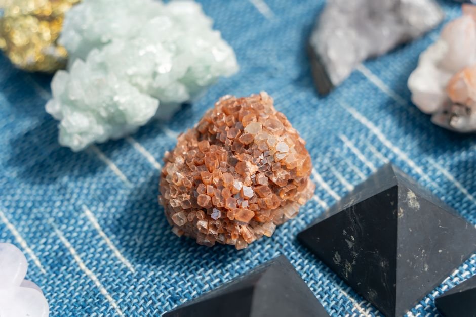 How to Avoid Fake Crystals — Buy From Sellers Who Know Their Stones Raw mineral specimens displayed on a dealer's market cloth, the kind of transparent sourcing worth buying from