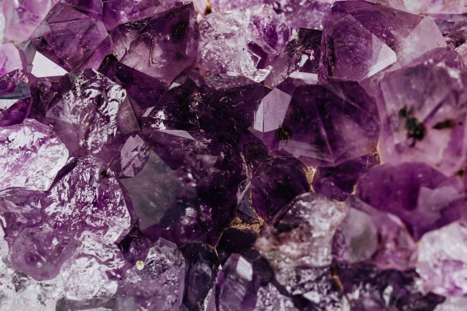 The Crystal Wellness Market — Billions in Sales, Supply Under Pressure Bulk pile of rough amethyst pieces awaiting processing, the wholesale scale behind the crystal boom