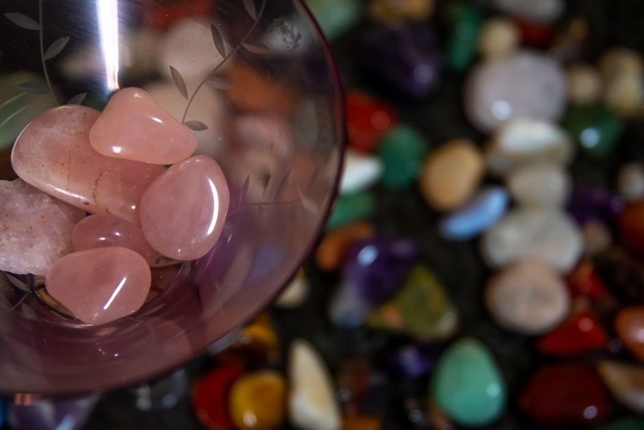Broken Rose Quartz Repurposed — Polished Pieces From a Cracked Sphere Polished rose quartz tumbled stones gathered in a glass, like a broken sphere reshaped into smaller usable pieces