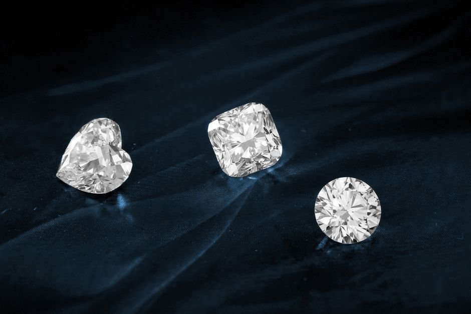 Professional Gemstone Appraisal — When to Skip DIY Testing Three cut diamonds on dark velvet, the kind of valuable stones that deserve a lab report instead of a scratch test