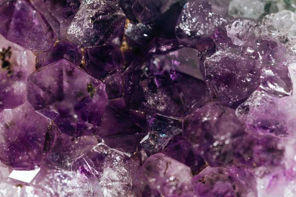Deep purple natural amethyst crystals that still show lighter zones and clear patches throughout