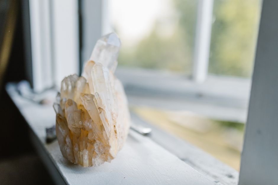 Quartz crystal cluster sitting on a sunny windowsill, the kind of prolonged sunlight exposure that can fade amethyst