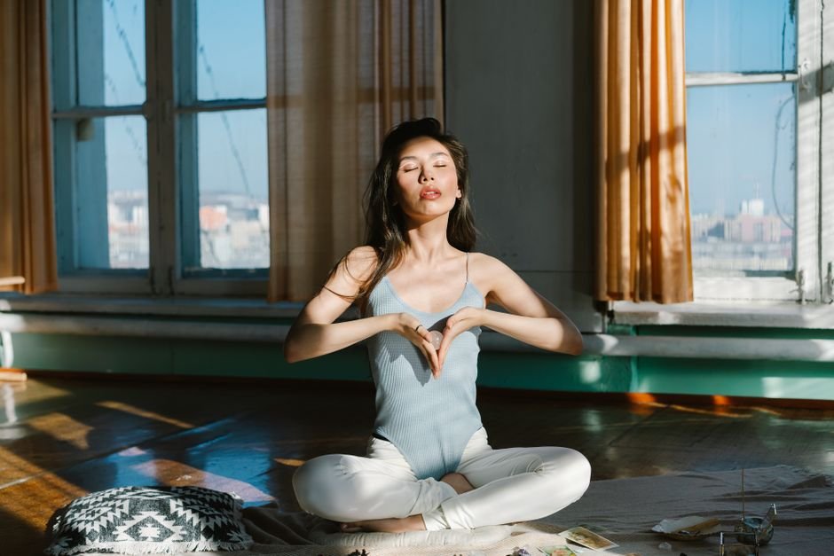 Placebo Effect and Crystals — Real vs Fake Felt Exactly the Same Woman meditating in sunlight, the setting where real and fake crystals produced identical reported effects in research
