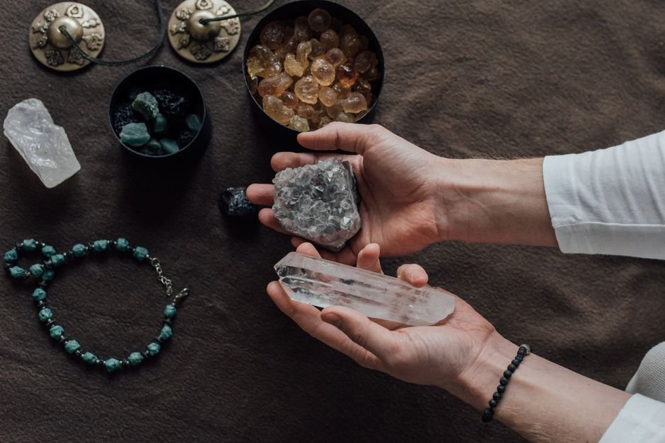 does a fake crystal have any energy — two hands comparing different quartz pieces that feel identical to hold