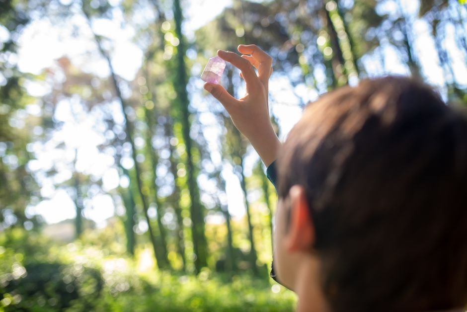 how can I tell if my crystal is real — holding a small quartz crystal up to sunlight to check clarity and inclusions
