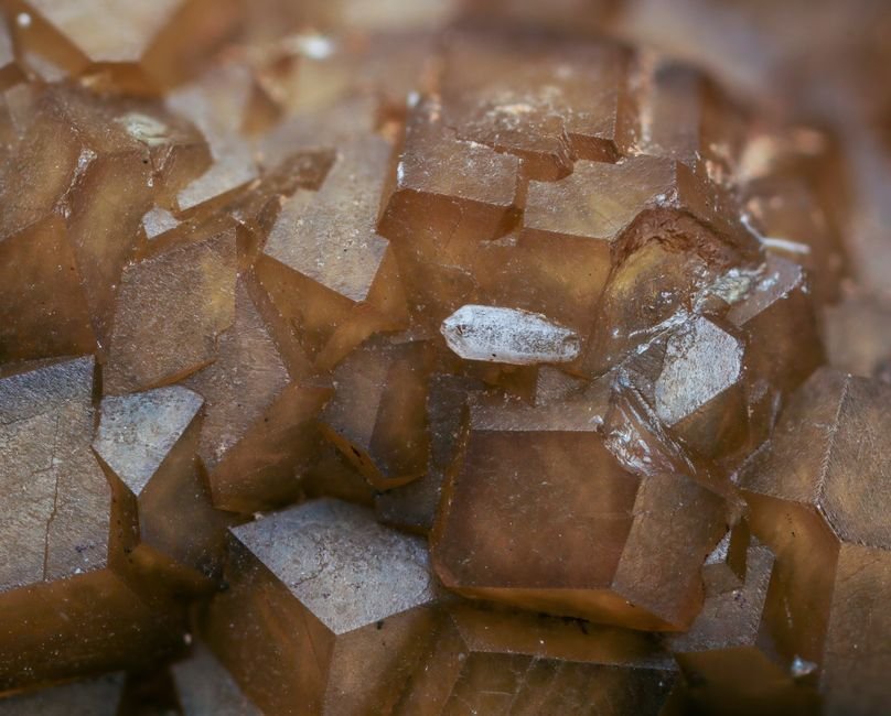 Mineral Cleavage Plane — Why Calcite Splits Cleanly in Half Brown calcite crystals with visible rhombic faces, the textbook example of a mineral cleavage plane