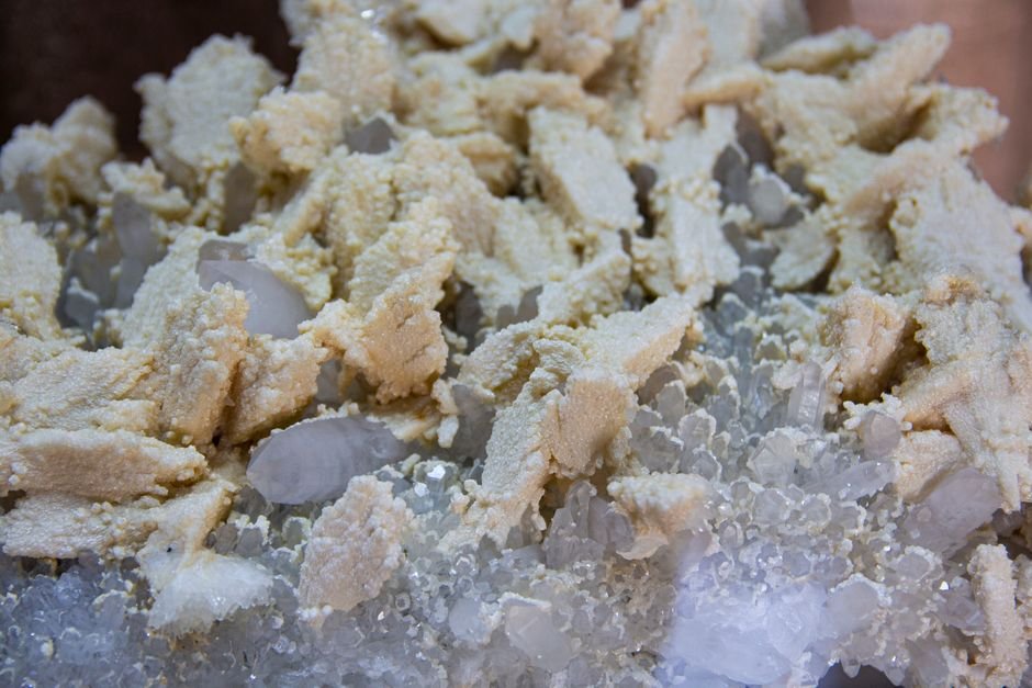 Crystal surface showing pale beige mineral deposits left behind by evaporating water