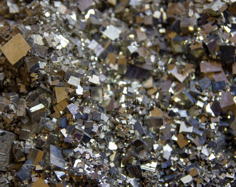 Pyrite Decay — The One Kind of Darkening That Cannot Be Cleaned Macro view of brassy pyrite crystals on rough matrix, the mineral most prone to genuine oxidation