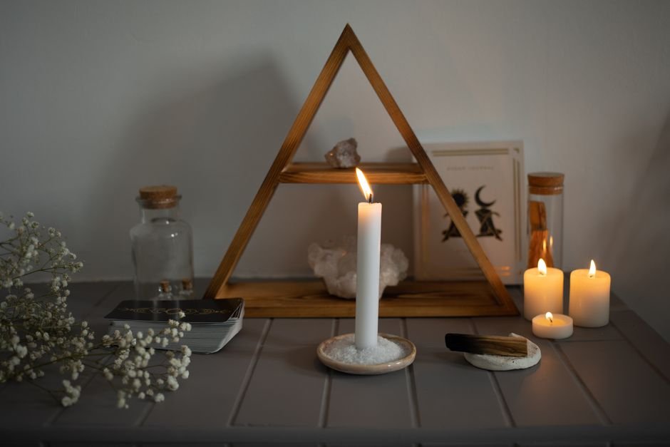 Candles Deposit Carbon Soot Directly Onto Nearby Crystals A candlelit altar arrangement with crystals set among burning candles, a common source of soot on nearby stone surfaces