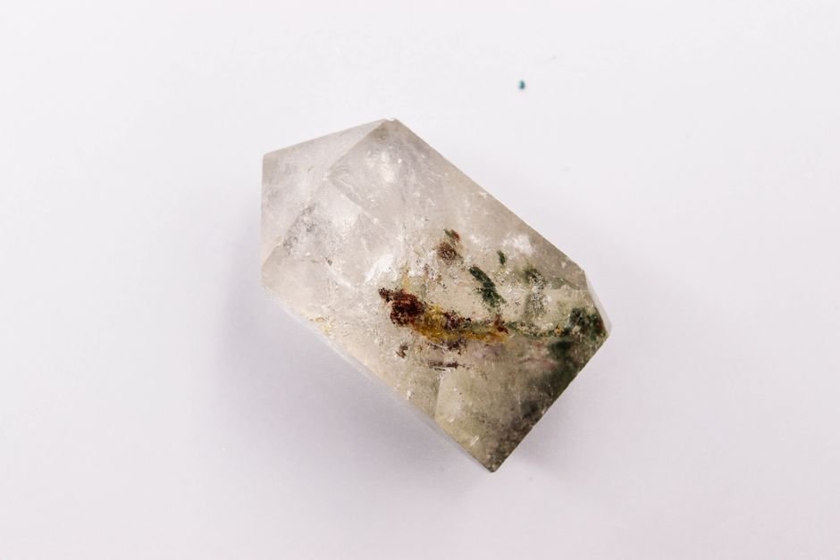 Macro view of a clear quartz crystal with visible internal inclusions and veils