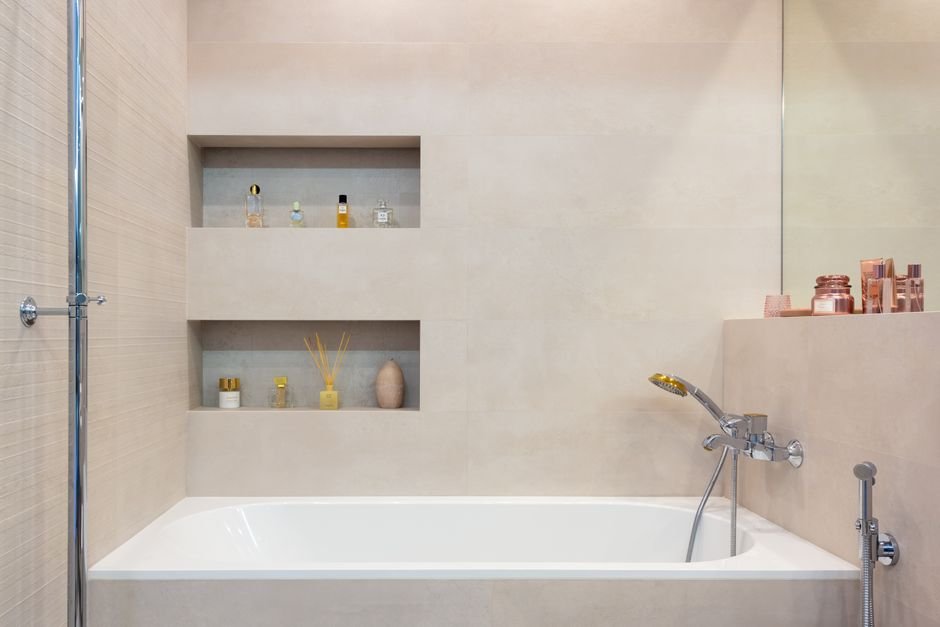 Modern bathroom with white bath, shower and open shelving, the humid room where selenite degrades fastest