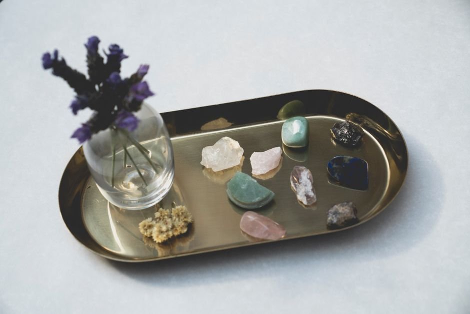 Polished gemstones laid out separately on a metal tray instead of piled together